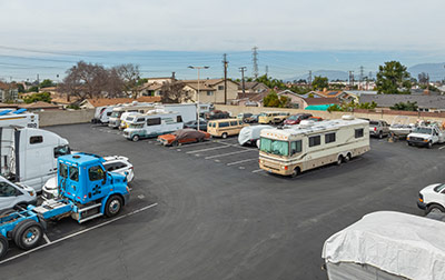 Outdoor parking for vehicles including RVs, boats, and cars.