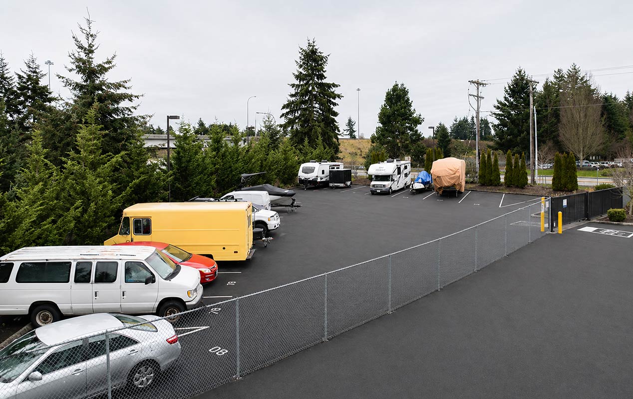 Outdoor parking for vehicles including RVs, boats, and cars.