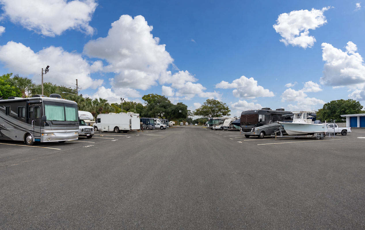 Outdoor parking for vehicles including RVs, boats, and cars.