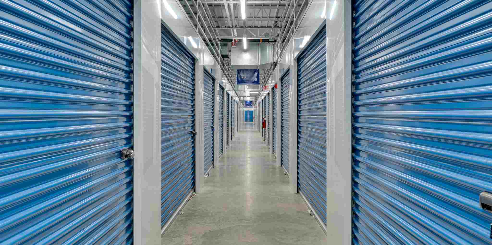 Indoor storage hallway lined with roll-up unit doors